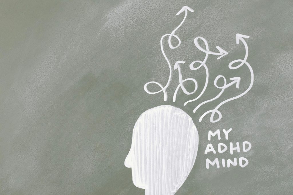 Creative depiction of the ADHD mind with chalk arrows on a green board.